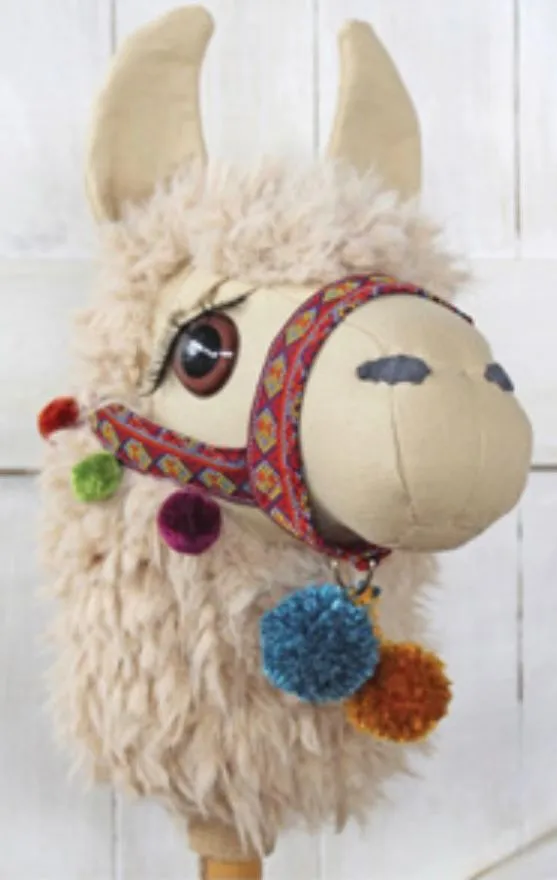 Handmade llama hobby horse - detail view showing embroidered eyes and woven halter